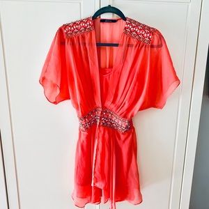 Lightweight, semi sheer, coral sequined top.